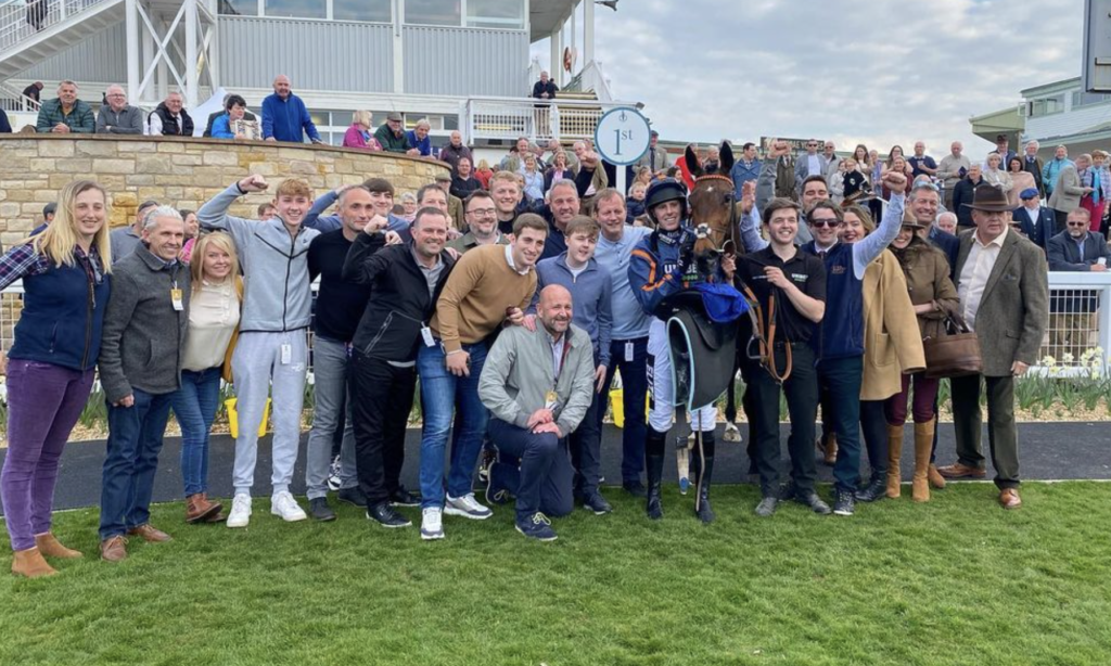 Canter Banter team celebrates first place with Theatre Glory and jockey Nathan Brennan at Kelso Racecourse in the Herring Queen Series Final Mares' Novices' Handicap Hurdle